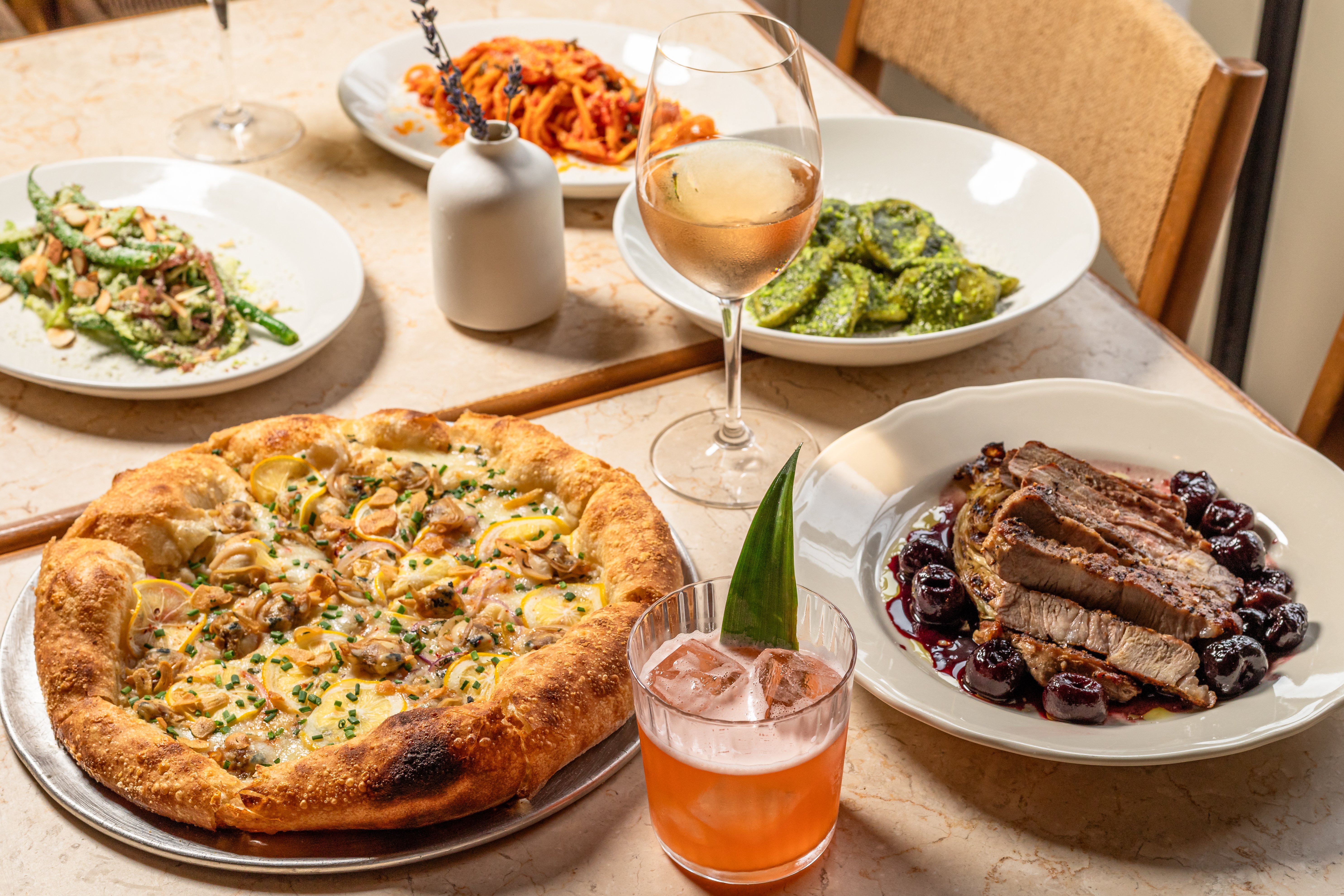 Plates of food and drinks on a restaurant table