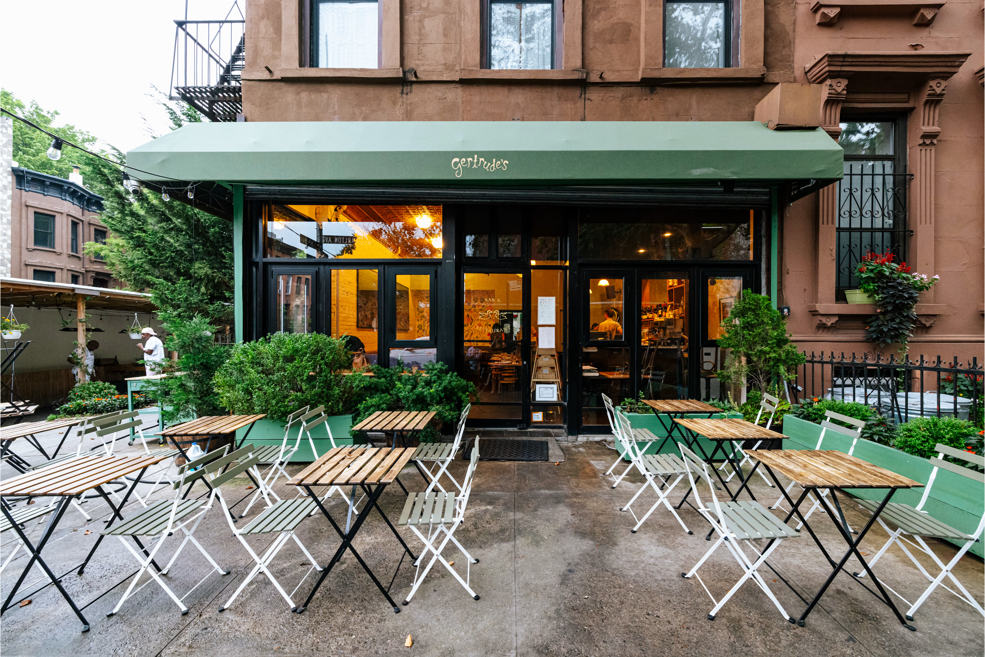 Restaurant storefront with sidewalk tables set up for service