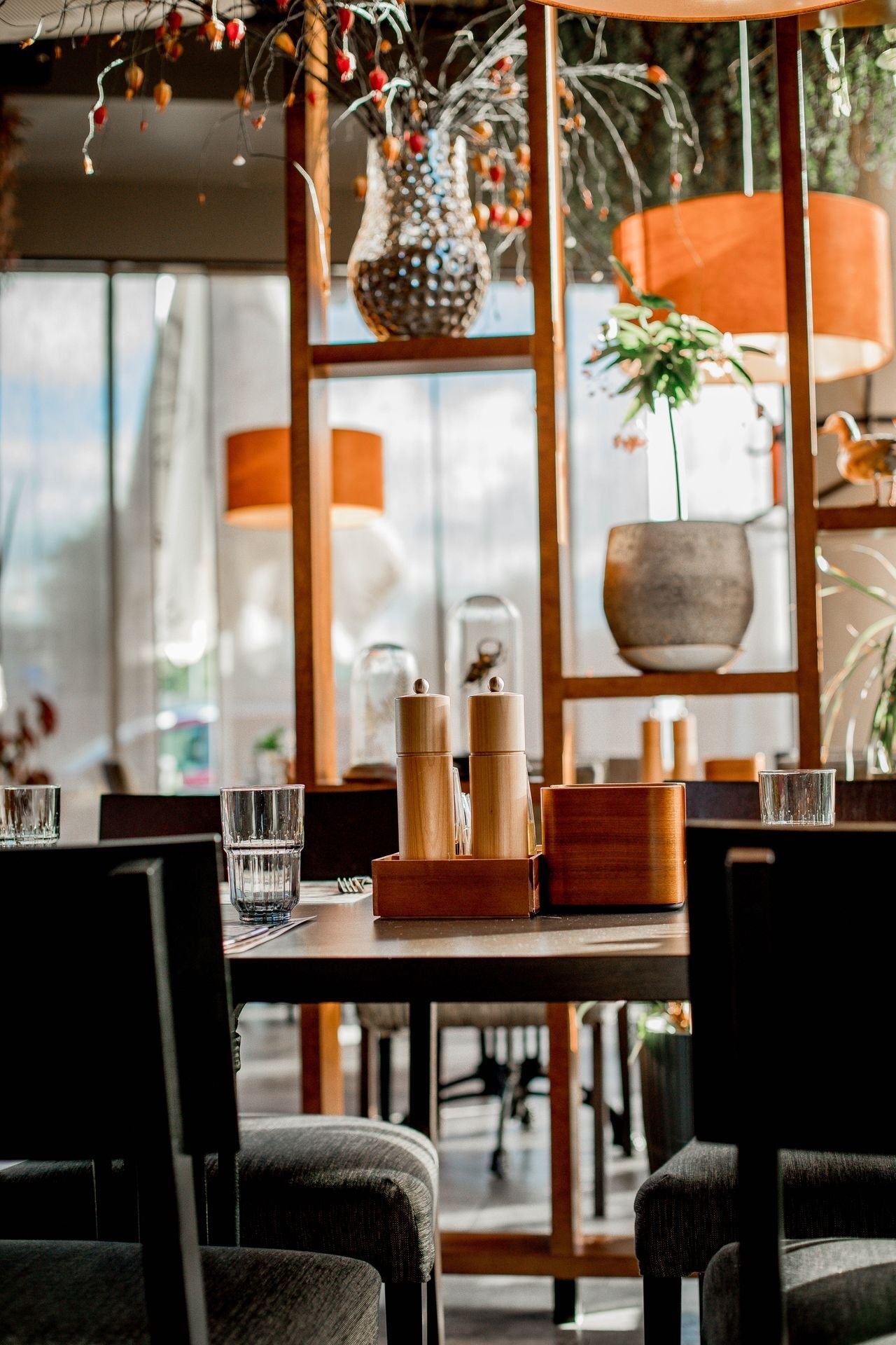 Bright restaurant dining room with tables set for the day