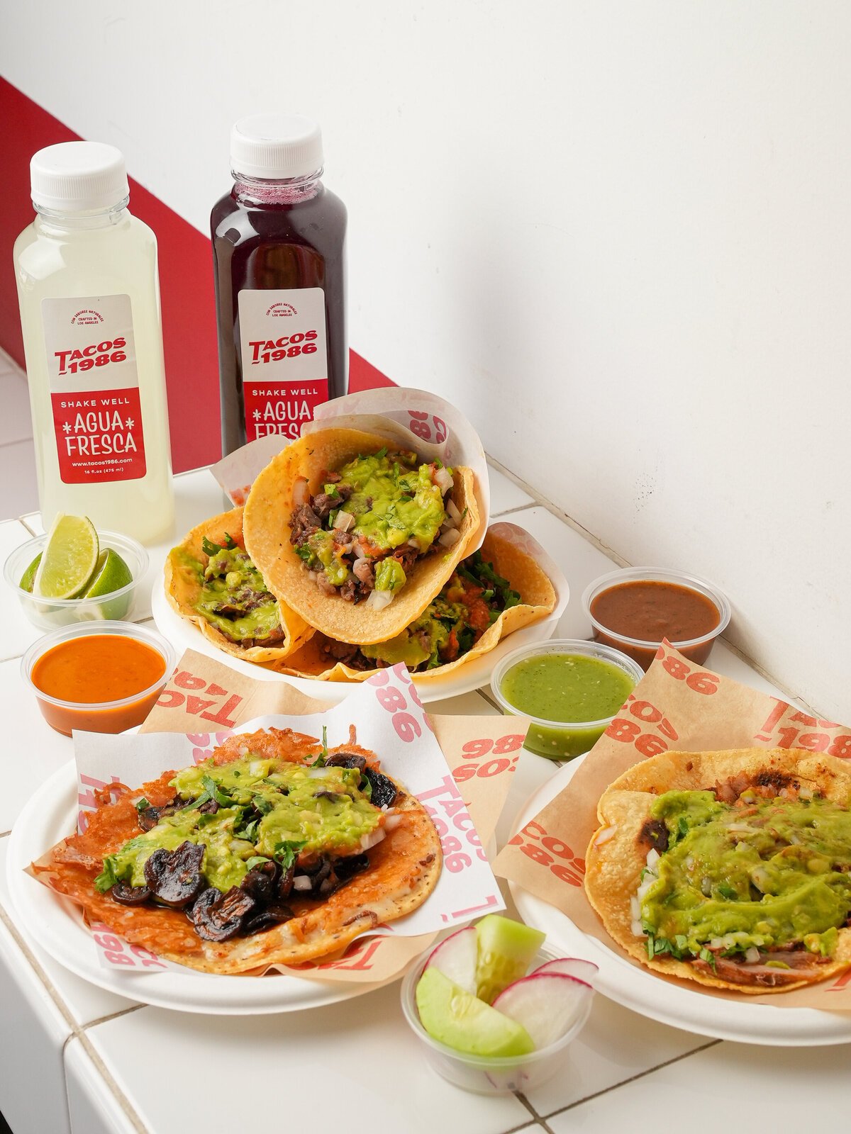 Tacos, salsas and aguas frescas spread across a table